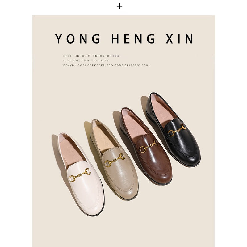 Women with horseshoe buckles and loafers wearing flat bottomed small leather shoes