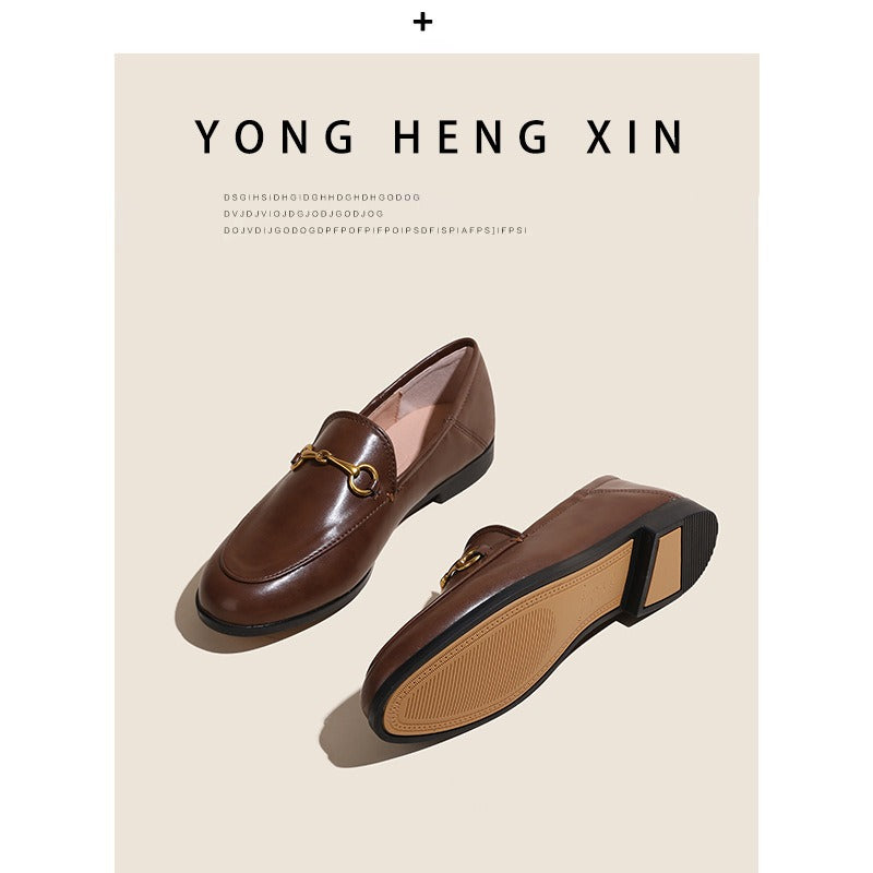 Women with horseshoe buckles and loafers wearing flat bottomed small leather shoes